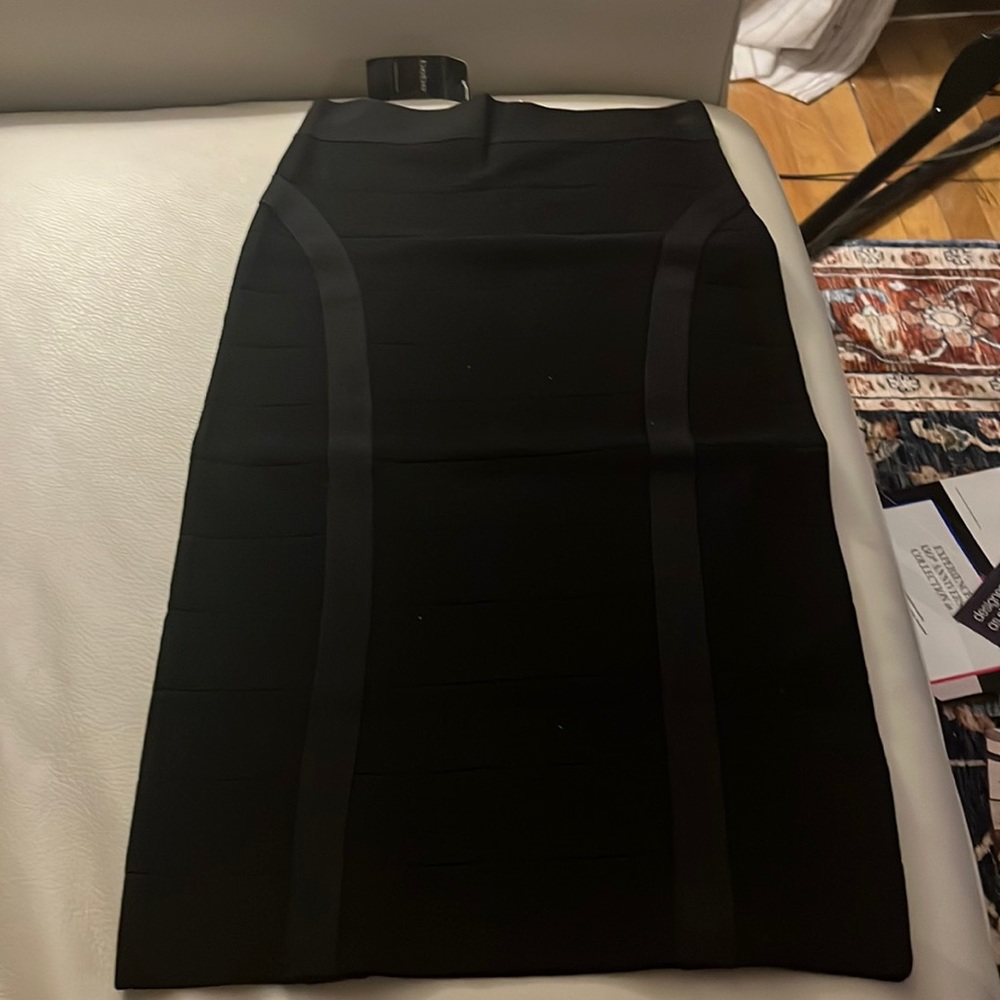Black knit fitted pencil skirt hits below the knees